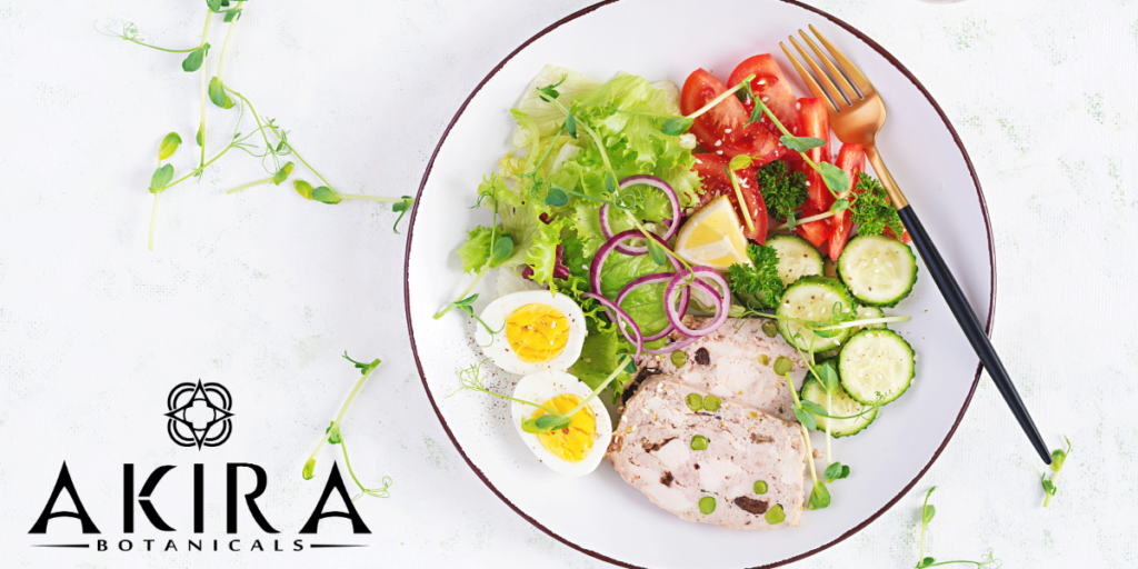 A plate of healthy food with eggs, lettuce, red onion, and other fruits and vegetables. 
