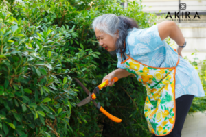 Woman bent over gardening with a sore back. 